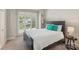 Inviting bedroom featuring a large window, plush carpet, and a comfortable bed with stylish pillows at 7626 Vistaview Dr, Cornelius, NC 28031