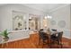 Elegant dining room with hardwood floors, stylish chandelier, and views into the living room at 7626 Vistaview Dr, Cornelius, NC 28031