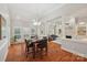 Open-concept dining area with hardwood floors, bright light, and a view of the living room at 7626 Vistaview Dr, Cornelius, NC 28031