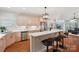 Modern kitchen with a breakfast bar, stainless steel appliances, hardwood floors, and view to great room at 7626 Vistaview Dr, Cornelius, NC 28031