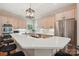 Open kitchen layout featuring a long island, stainless steel appliances, and bright lighting at 7626 Vistaview Dr, Cornelius, NC 28031