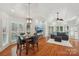 Open-concept living and dining area with hardwood floors and abundant natural light at 7626 Vistaview Dr, Cornelius, NC 28031