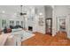 Bright living room featuring hardwood floors, fireplace with white mantle, and custom built-in shelving at 7626 Vistaview Dr, Cornelius, NC 28031