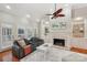 Bright living room with a fireplace, custom built-ins, hardwood floors, and a comfortable sofa at 7626 Vistaview Dr, Cornelius, NC 28031