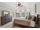 Comfortable primary bedroom with a ceiling fan, large windows, and neutral tones at 7626 Vistaview Dr, Cornelius, NC 28031