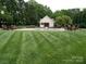 Community pool featuring tidy green grass and a pool house at 7626 Vistaview Dr, Cornelius, NC 28031