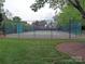 Well-maintained community tennis court with green surroundings and fencing at 7626 Vistaview Dr, Cornelius, NC 28031