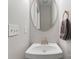 Close-up of half bathroom sink with a round mirror, white walls, and a towel at 7748 Long Bay Pkwy, Catawba, NC 28609