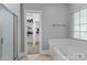 Bathroom featuring tub, walk-in closet access, and glass shower at 7748 Long Bay Pkwy, Catawba, NC 28609