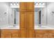 Bathroom with double sinks, wood cabinets, and a central linen closet at 7748 Long Bay Pkwy, Catawba, NC 28609