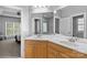 Bathroom with dual sinks, a large mirror, and view into bedroom at 7748 Long Bay Pkwy, Catawba, NC 28609