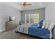 Bedroom with tray ceiling, ceiling fan, tv, and large window at 7748 Long Bay Pkwy, Catawba, NC 28609