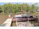 Dock with a covered boat slip on the lake, surrounded by lush trees at 7748 Long Bay Pkwy, Catawba, NC 28609
