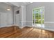 Bright, empty room with natural light, crown molding, and pristine hardwood floors at 7748 Long Bay Pkwy, Catawba, NC 28609