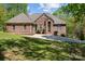 Charming brick home with well-manicured lawn, mature trees, and a spacious driveway leading to the entrance at 7748 Long Bay Pkwy, Catawba, NC 28609