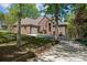 Charming brick home with lush landscaping, mature trees, and a spacious driveway leading to an attached garage at 7748 Long Bay Pkwy, Catawba, NC 28609