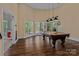 Bright game room featuring a pool table, wood floors, and natural light at 7748 Long Bay Pkwy, Catawba, NC 28609