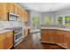Bright kitchen with stainless steel appliances, custom cabinets, modern countertops, and hardwood floors at 7748 Long Bay Pkwy, Catawba, NC 28609