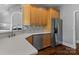 Modern kitchen featuring stainless steel appliances, quartz countertops, and warm wood cabinetry at 7748 Long Bay Pkwy, Catawba, NC 28609