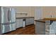Kitchenette with stainless steel fridge, gray cabinets, dark countertop, and wood floors at 7748 Long Bay Pkwy, Catawba, NC 28609