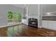 Inviting living room featuring a cozy fireplace, custom built-ins, gleaming wood floors and natural light at 7748 Long Bay Pkwy, Catawba, NC 28609