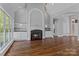 Inviting living room featuring a cozy fireplace, custom built-ins, gleaming wood floors and natural light at 7748 Long Bay Pkwy, Catawba, NC 28609