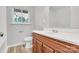 Bathroom boasts a classic vanity with storage, with neutral paint and a window at 801 Bilmark Ave, Charlotte, NC 28213