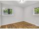 Bright bedroom featuring hardwood floors and natural light from the two windows at 801 Bilmark Ave, Charlotte, NC 28213