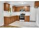 Eat-in kitchen featuring stainless steel appliances, a window view and decorative tile backsplash at 801 Bilmark Ave, Charlotte, NC 28213