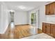 Spacious dining room showcasing wood flooring and sliding glass doors to the outdoor deck at 801 Bilmark Ave, Charlotte, NC 28213