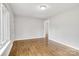 An open living room is adorned with light gray walls and beautiful, gleaming hardwood floors at 801 Bilmark Ave, Charlotte, NC 28213