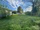 Backyard with grassy lawn, boat, garage and storage building, with trees on the horizon at 829 Green St, Salisbury, NC 28144