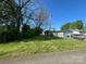 Backyard featuring garage, storage building and a car with a grassy lawn at 829 Green St, Salisbury, NC 28144