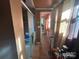 Hallway leading to bathroom and shower with tile floors and glass door at 829 Green St, Salisbury, NC 28144