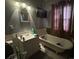 Bathroom featuring a tub, vanity, mirror, wall-mounted TV and tile floors at 829 Green St, Salisbury, NC 28144