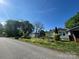 Exterior view of the single story home and detached garage with mature trees at 829 Green St, Salisbury, NC 28144