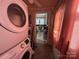 Laundry area featuring a stacked washer and dryer, with tile floors at 829 Green St, Salisbury, NC 28144