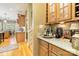 Dry bar area with granite countertops, custom cabinetry, and wine storage at 9200 Kingsmead Ln, Waxhaw, NC 28173