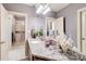 Well-lit bathroom with granite countertops, a double sink vanity, and access to a separate shower room at 9200 Kingsmead Ln, Waxhaw, NC 28173
