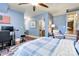Bright bedroom with hardwood floors, a plaid bedspread, and doorways leading to a bathroom and another room at 9200 Kingsmead Ln, Waxhaw, NC 28173