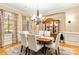 Elegant dining room featuring a chandelier, china cabinet, and neutral decor at 9200 Kingsmead Ln, Waxhaw, NC 28173