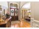 Inviting foyer with hardwood floors, arched doorways, and a view into the formal dining room at 9200 Kingsmead Ln, Waxhaw, NC 28173
