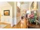 Grand foyer with hardwood floors, wainscoting, and a view of the staircase and living spaces at 9200 Kingsmead Ln, Waxhaw, NC 28173