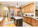 Beautiful kitchen with stainless steel appliances, granite countertops, and a dark wood island at 9200 Kingsmead Ln, Waxhaw, NC 28173