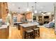 Open-concept kitchen featuring a central island with bar seating and flowing into a cozy living space at 9200 Kingsmead Ln, Waxhaw, NC 28173
