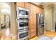Well-equipped kitchen featuring stainless steel appliances and custom wood cabinetry for ample storage and style at 9200 Kingsmead Ln, Waxhaw, NC 28173