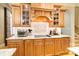 Custom kitchen with a stylish hood vent, tiled backsplash, and granite countertops at 9200 Kingsmead Ln, Waxhaw, NC 28173