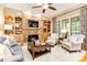 Cozy living room featuring a stone fireplace, built-in shelving, and comfortable seating for relaxation at 9200 Kingsmead Ln, Waxhaw, NC 28173