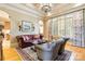 Elegant living room with stylish seating, a decorative rug, and ample natural light from large windows at 9200 Kingsmead Ln, Waxhaw, NC 28173