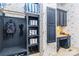 Mudroom with a built-in storage bench, shelves, cubbies, hooks, storage, and a desk with blue cabinetry at 9200 Kingsmead Ln, Waxhaw, NC 28173